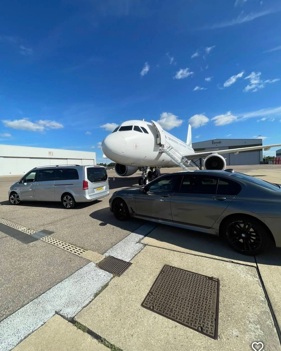 Mercedes V-Class and BMW 7 Series meeting a private jet on the airport apron